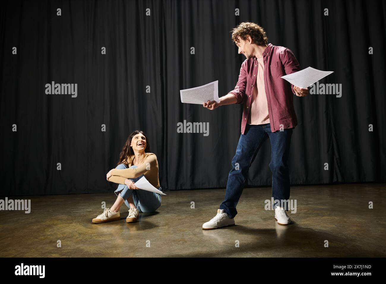 A man and woman working on their lines together during theater rehearsals. Stock Photo
