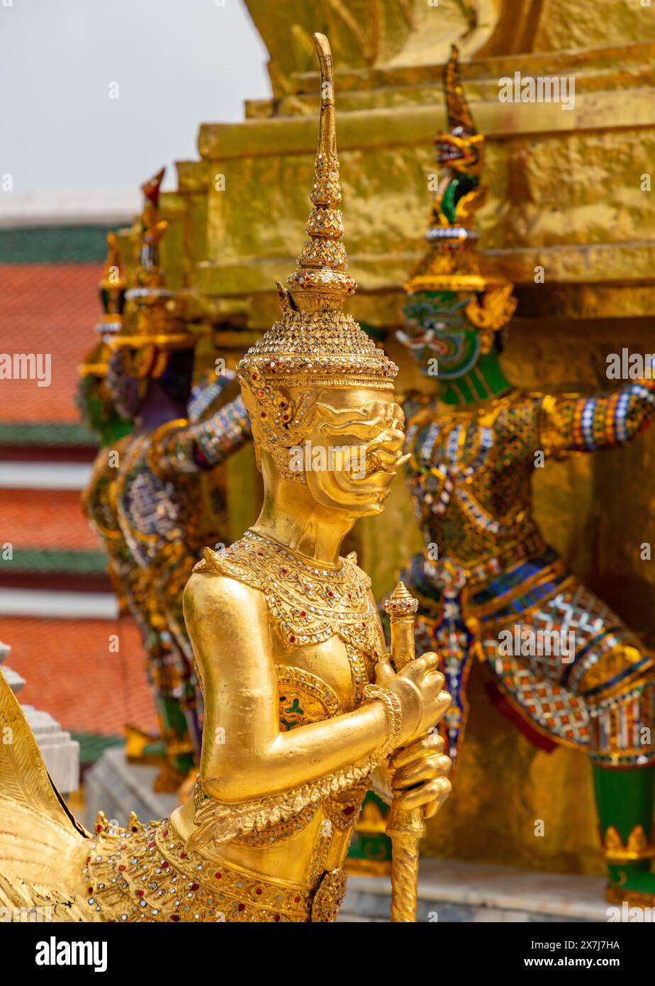 A picture of a golden warrior statue at the Grand Palace of Bangkok ...