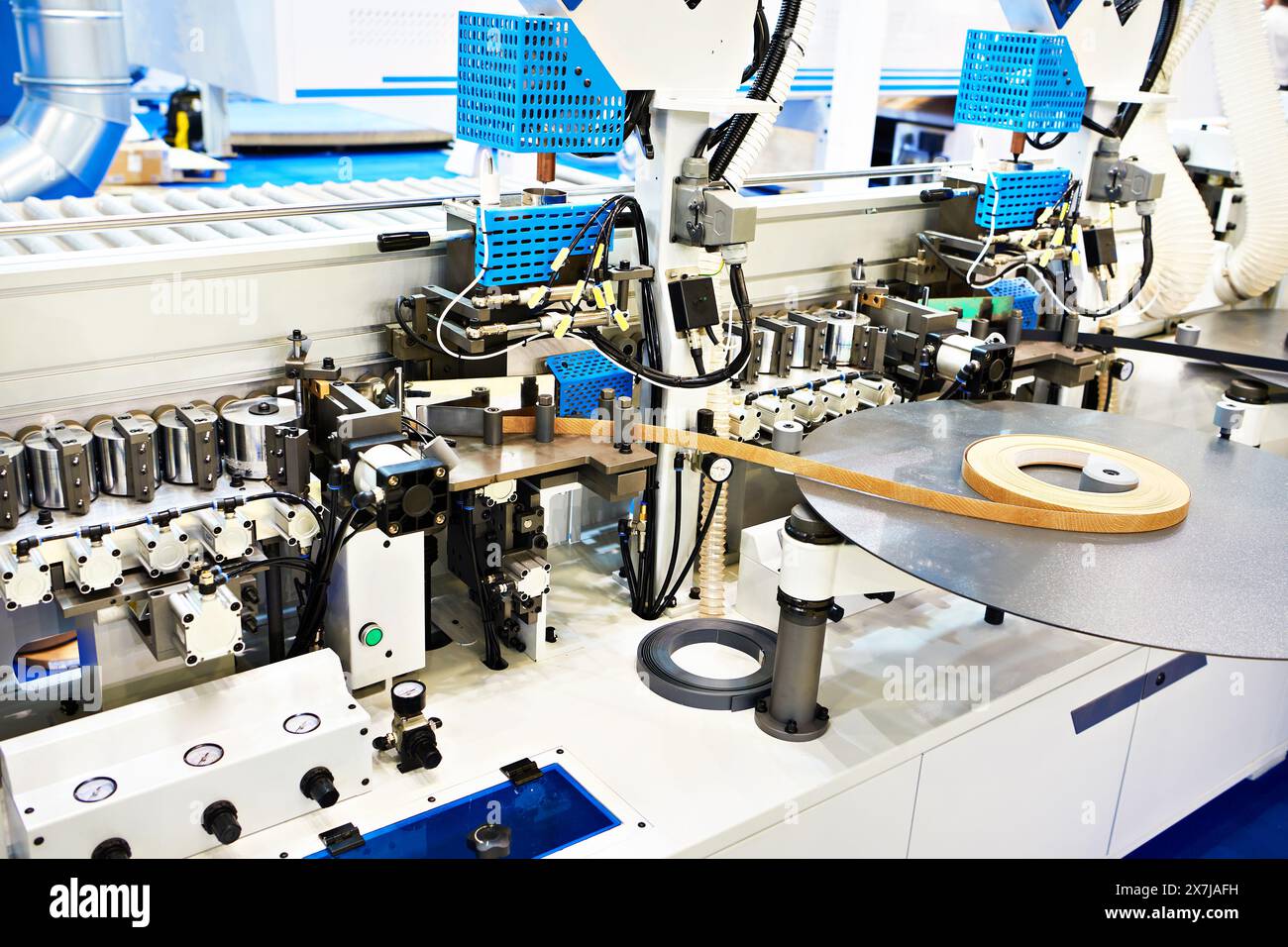 Single sided automatic edge banders on factory Stock Photo