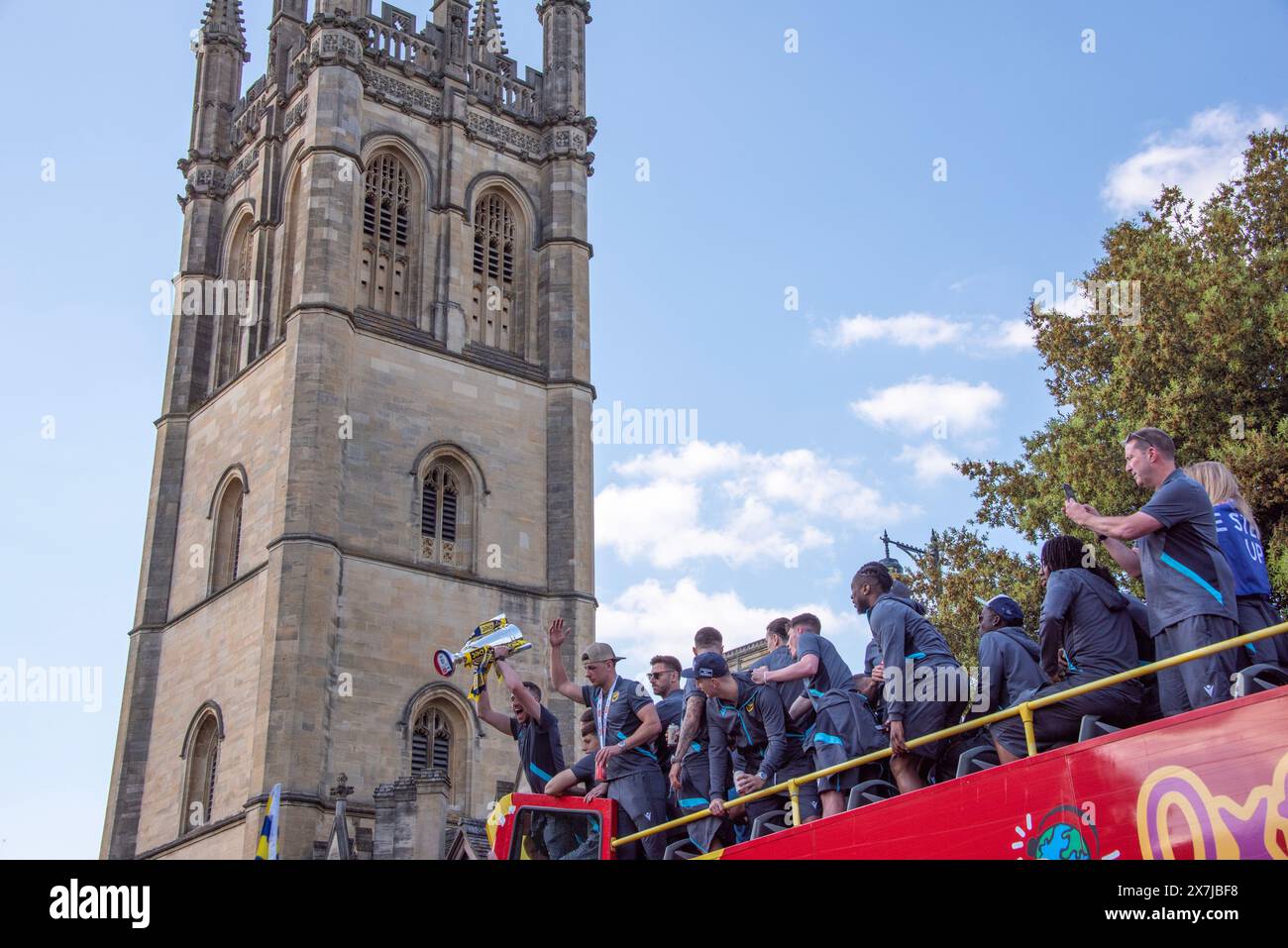 Oxford, May 20th 2024. Oxford United pass Magdalen Tower on an open top bus through the city's streets to celebrate their 2–0 win over Bolton Wanderers in the play-off final and promotion to the Championship again after 25 years.  Credit: Martin Anderson/Alamy Live News Stock Photo