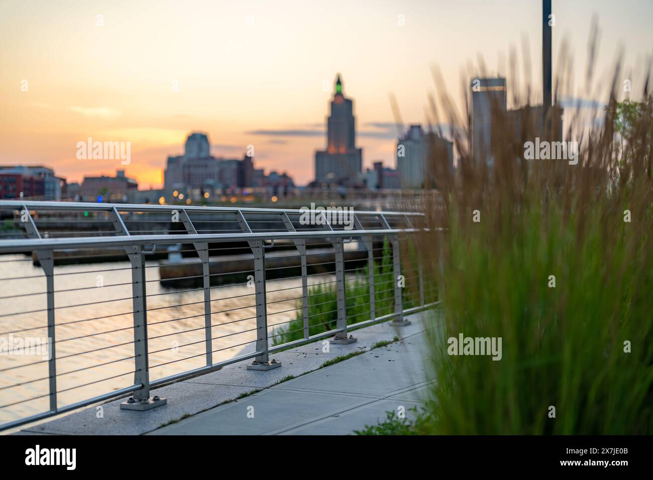Stainless steel railing along a public exterior wooden board walk in an ...