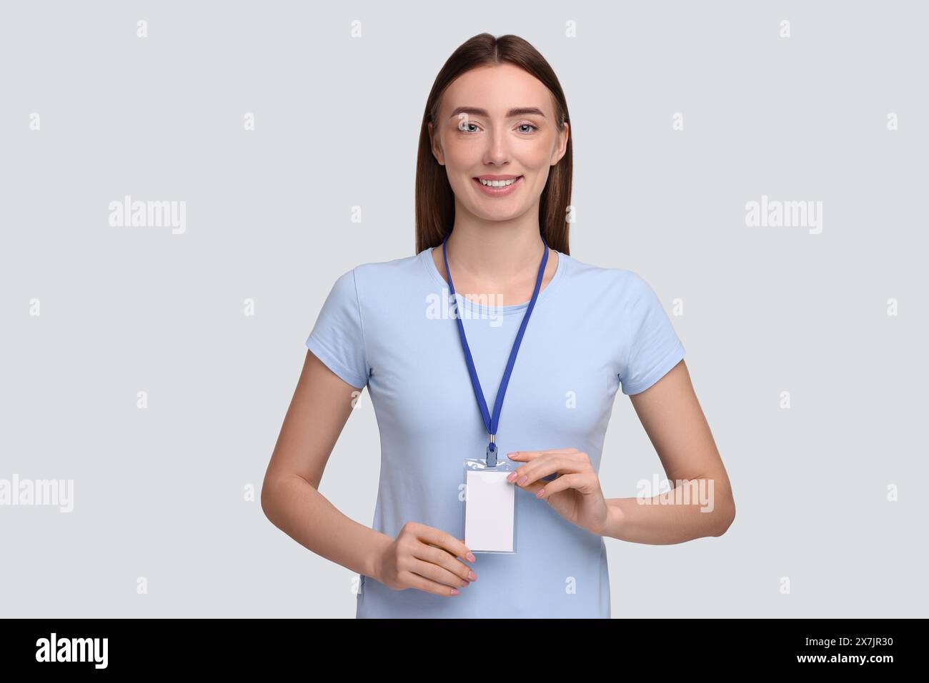 Woman with blank badge on grey background Stock Photo - Alamy