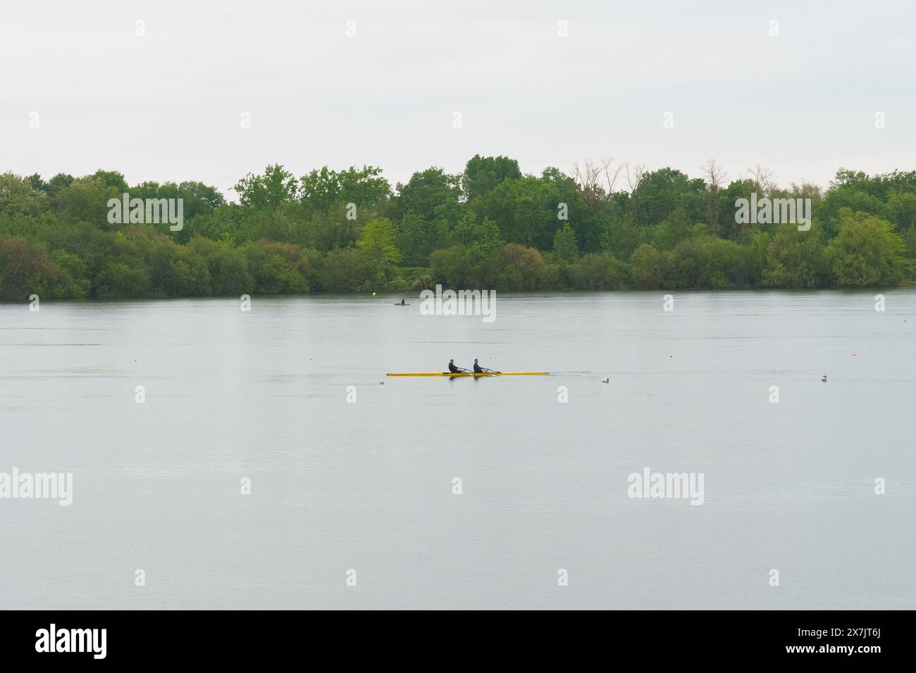 Bordeaux, France - April 26, 2023: Two individuals are rowing a boat on a vast lake. Stock Photo
