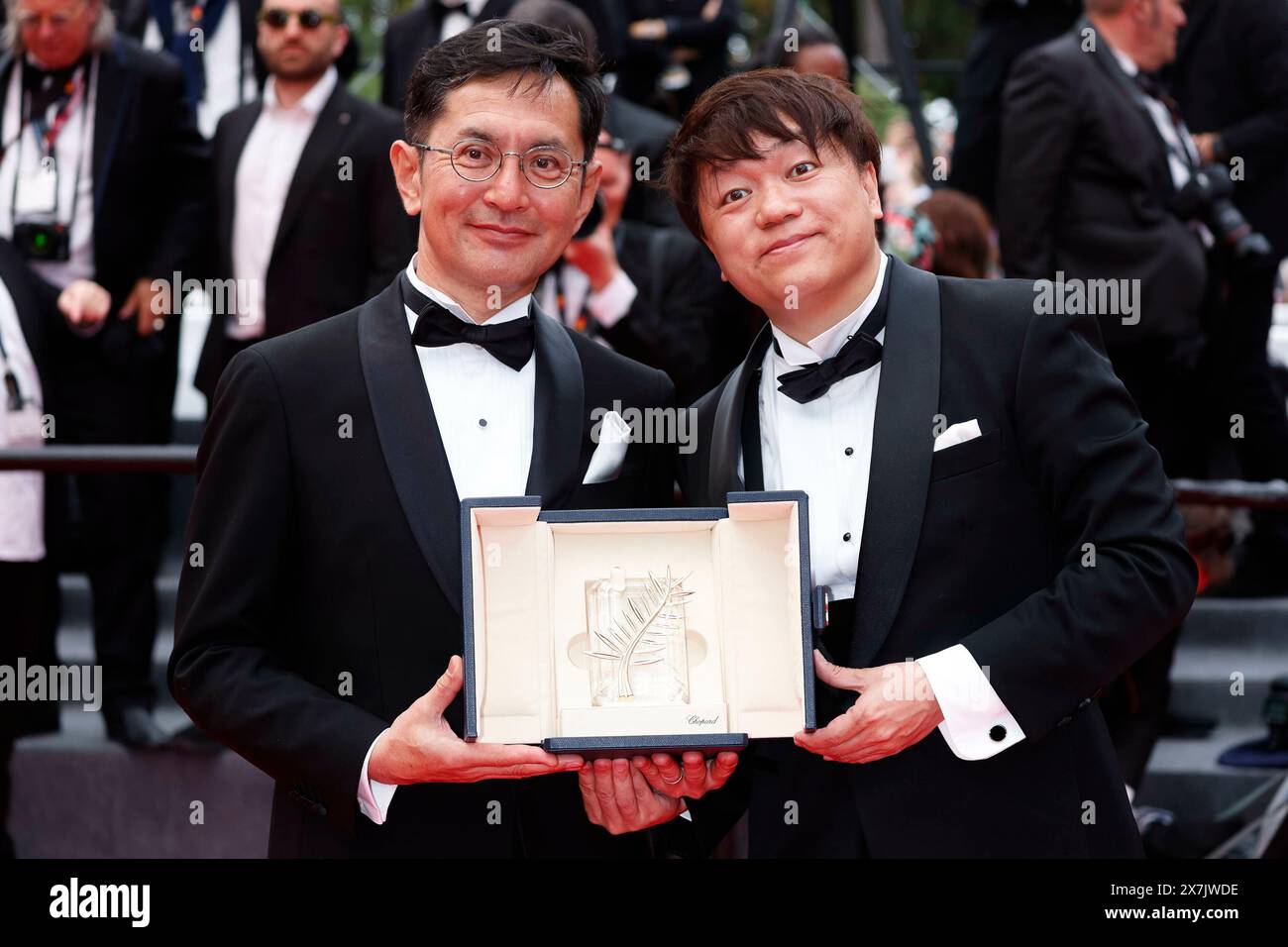 Goro Miyazaki and Kenichi Yoda pose with the Golden Palm for Studio