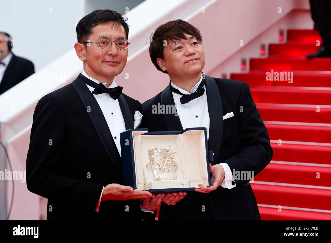 Goro Miyazaki and Kenichi Yoda pose with the Golden Palm for Studio