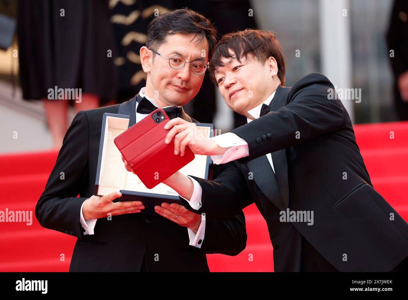 Goro Miyazaki and Kenichi Yoda pose with the Golden Palm for Studio