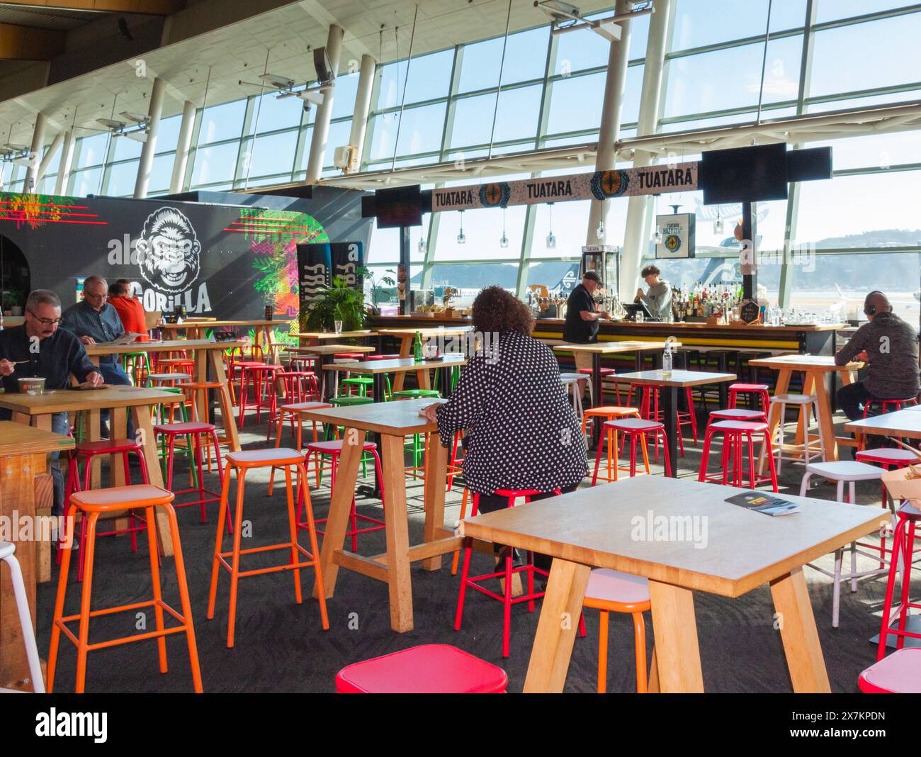 Wellington, New Zealand - February 21, 2024: Passengers dining at Gorilla Burger prior to their flights at Wellington International Airport. Stock Photo