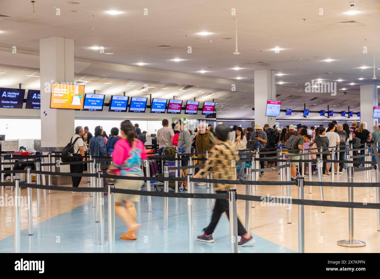 Auckland, New Zealand - February 21, 2024: Passengers checking in for their flights at Auckland International Airport. Stock Photo