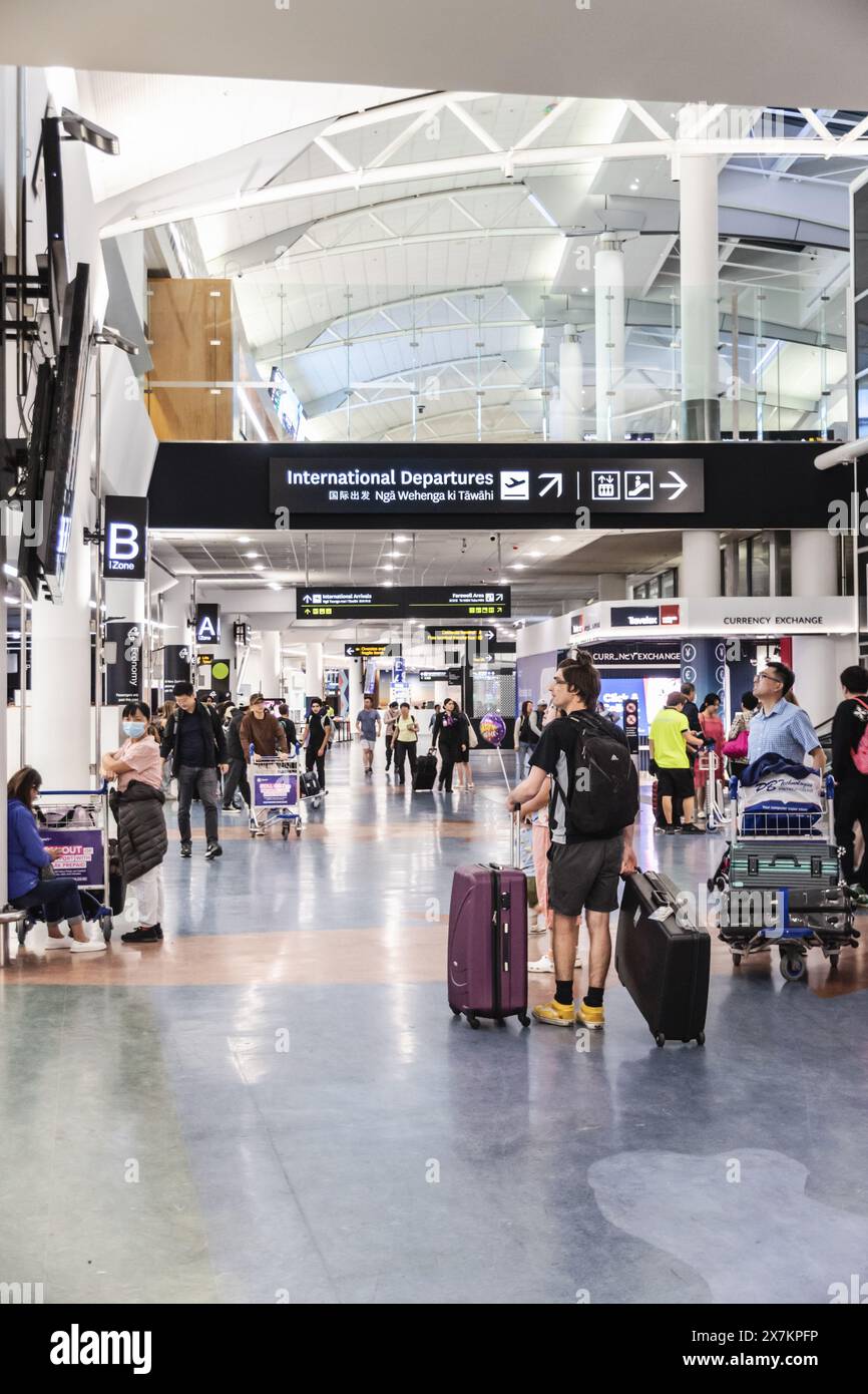 Auckland, New Zealand - February 21, 2024: Travelers inside at the Auckland International Airport. Stock Photo