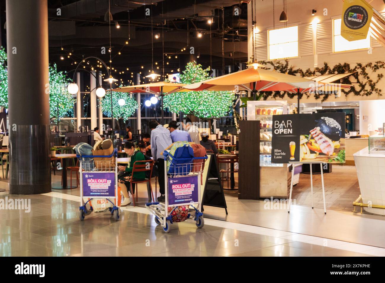 Auckland, New Zealand - February 21, 2024: Travelers dining at Oma, Artisan Bakery and Cafe located inside Auckland International Airport. Stock Photo