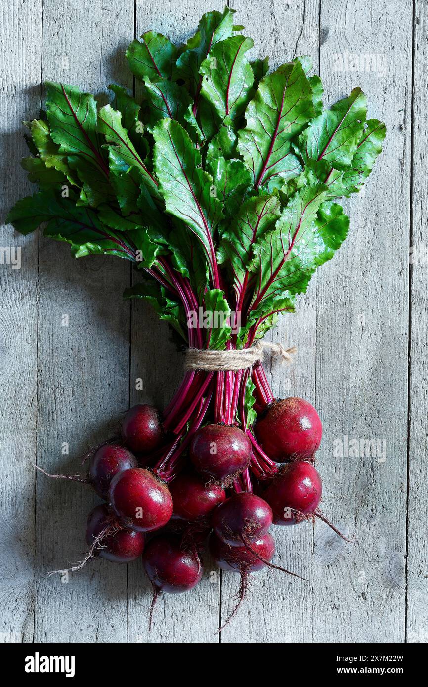 Bunch of fresh beetroots over a gray wooden backround Stock Photo