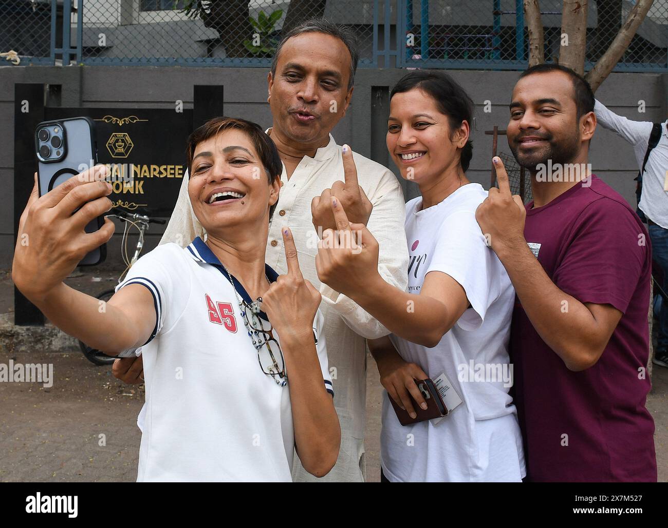 Mumbai, India. 20th May, 2024. People take a selfie with inked finger after casting their vote in Mumbai. Polling was for six seats of the Loksabha election in Mumbai. These six seats were Mumbai North, Mumbai North West, Mumbai North East, Mumbai North Central, Mumbai South Central and Mumbai South. Maharashtra state recorded a lowest voter turnout of 54 percent. Credit: SOPA Images Limited/Alamy Live News Stock Photo