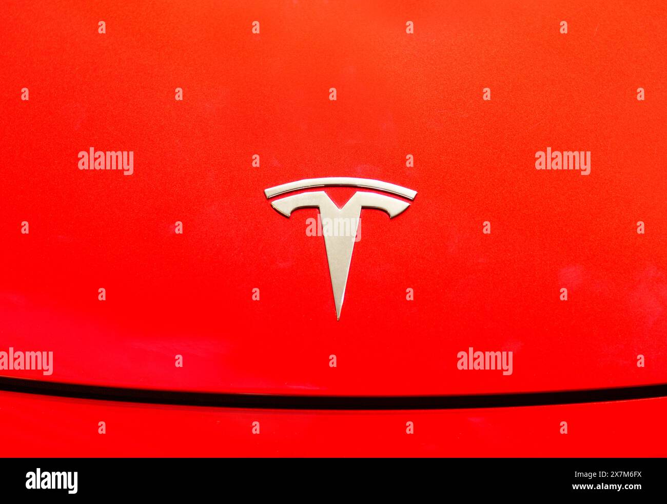 Bangkok ,Thailand ,May -15, 2024 : Close up of Tesla logo on tesla model 3 red background at dealer showroom in siam paragon Stock Photo