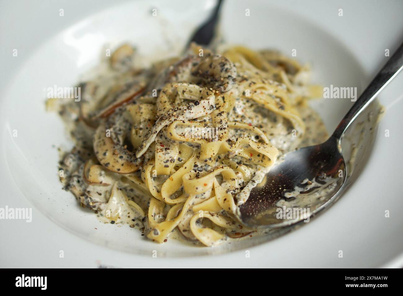 Truffle tagliatelle spaghetti, unique and earthy flavor of black truffles made simple way with pasta. Pasta plate in Argentina steakhouse restaurant. Stock Photo