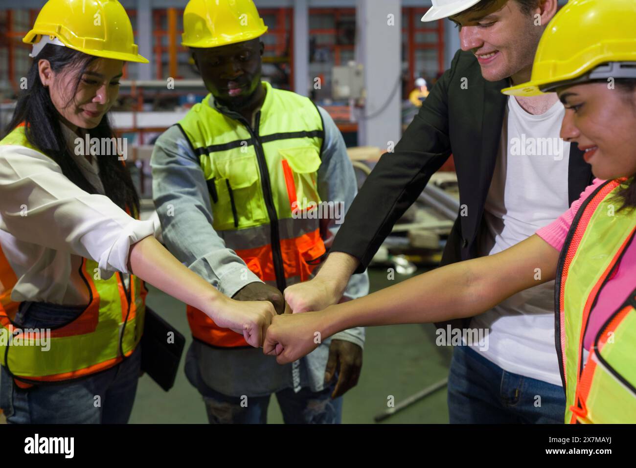 Group of construction workers clad in hard hats and reflective vests ...