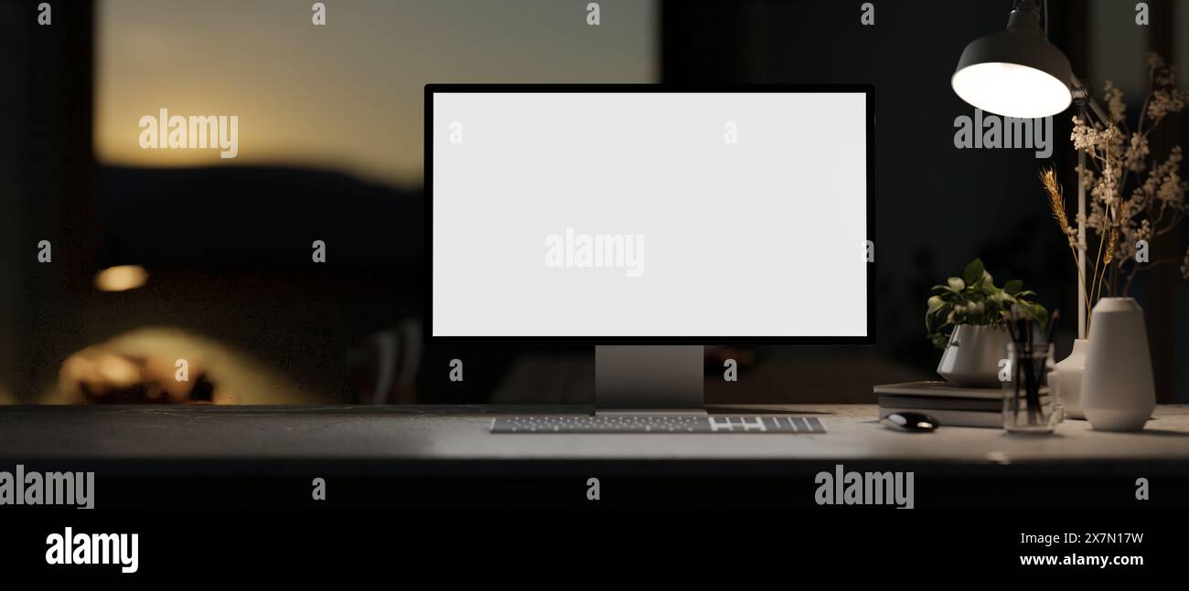 A white-screen computer mockup, decor, and a dim light from a lamp on a ...