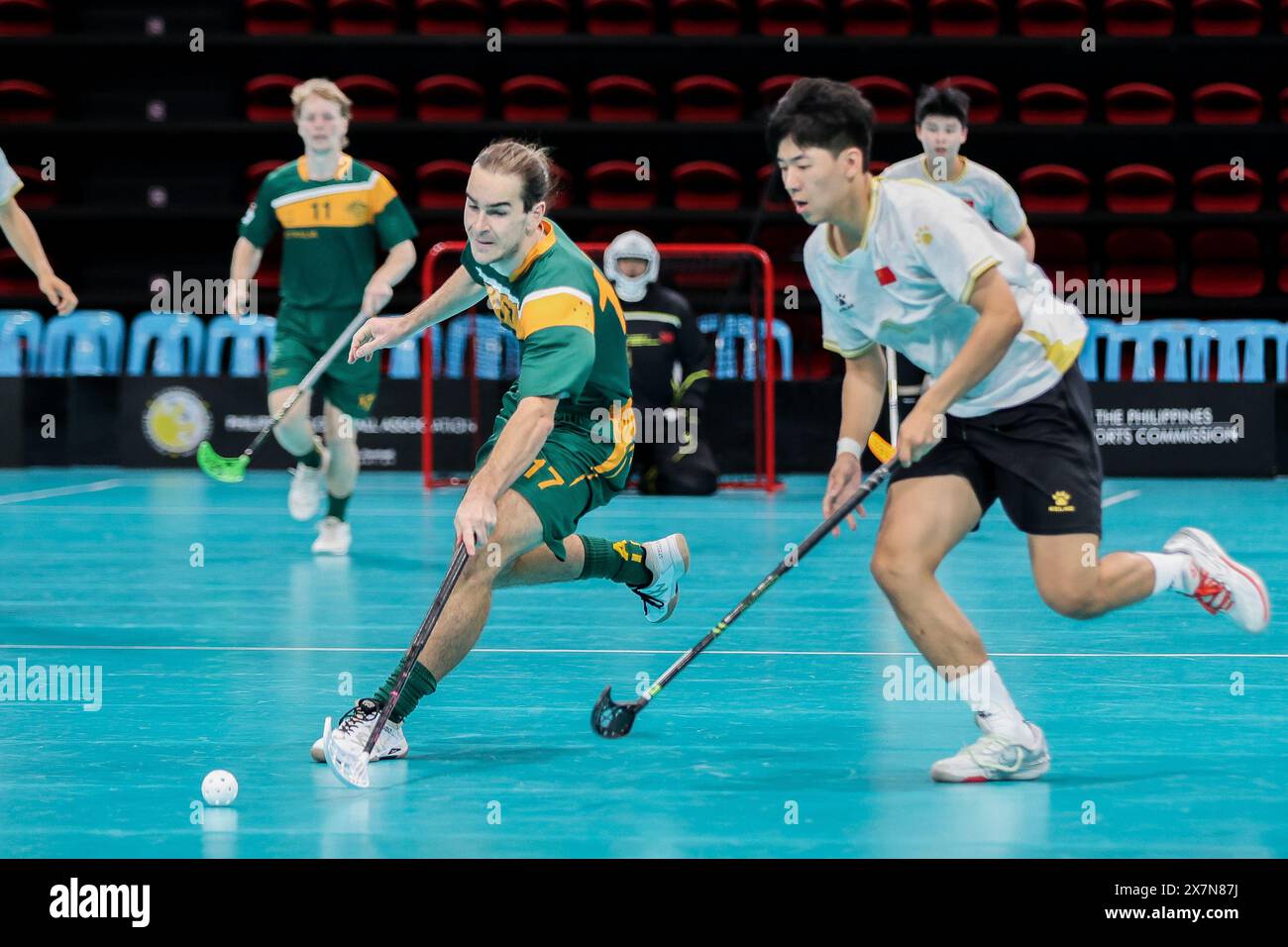 Pasig, Philippines. 21st May, 2024. Ben Hemmi (front L) of Australia vies for the ball during the 2024 Men's World Floorball Championships qualifications between China and Australia in Pasig, the Philippines, on May 21, 2024. Credit: Rouelle Umali/Xinhua/Alamy Live News Stock Photo