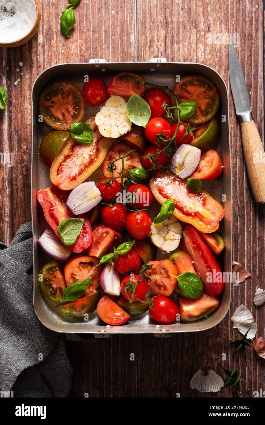 Fresh tomatoes with garlic, shallot and basil Stock Photo