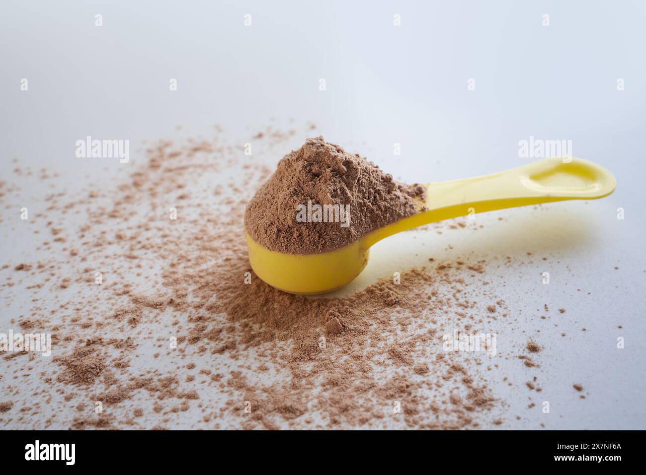 Close up of whey protein scoop on white background, copy space Stock Photo