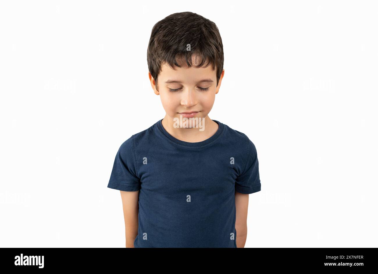 Child standing over white background embarrassed and looking down in ...