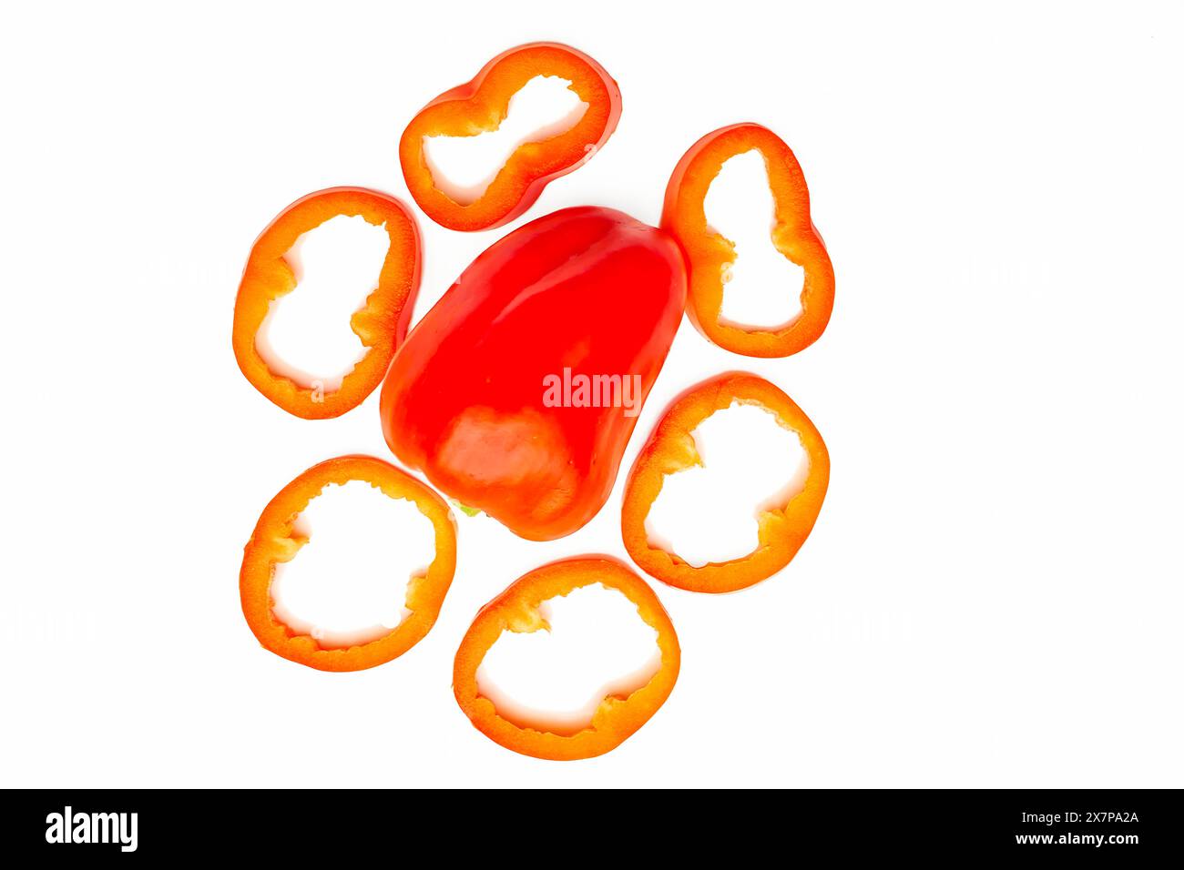 Red sweet ripe pepper cut into circles,slices on white Stock Photo