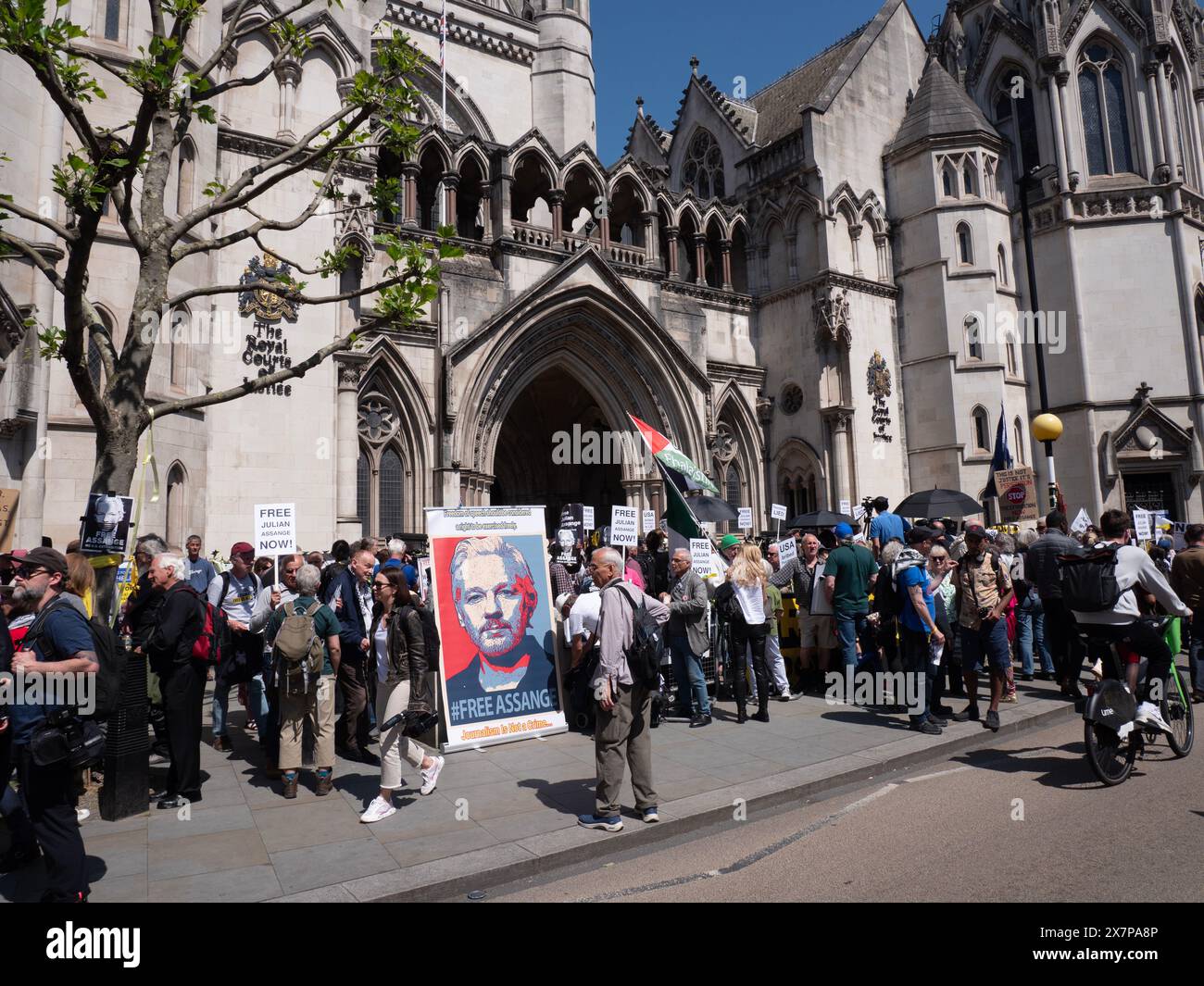 Supporters of WikiLeaks founder Julian Assange gather outside the Royal Courts of Justice (High Court) in London, UK, on 20 May 2024. They are awaiting a pivotal ruling on whether Assange can appeal his extradition to the United States on espionage charges. In a significant legal victory, two senior judges granted him the right to a full appeal, primarily on the grounds that his First Amendment rights might be limited due to his Australian nationality. This decision ultimately led to a plea deal and his release from Belmarsh Prison in June 2024 Stock Photo