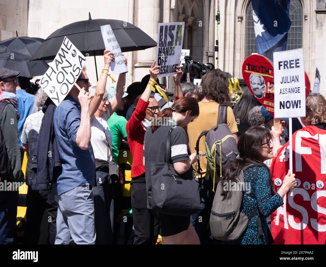 Supporters of WikiLeaks founder Julian Assange gather outside the Royal Courts of Justice (High Court) in London, UK, on 20 May 2024. They are awaiting a pivotal ruling on whether Assange can appeal his extradition to the United States on espionage charges. In a significant legal victory, two senior judges granted him the right to a full appeal, primarily on the grounds that his First Amendment rights might be limited due to his Australian nationality. This decision ultimately led to a plea deal and his release from Belmarsh Prison in June 2024 Stock Photo