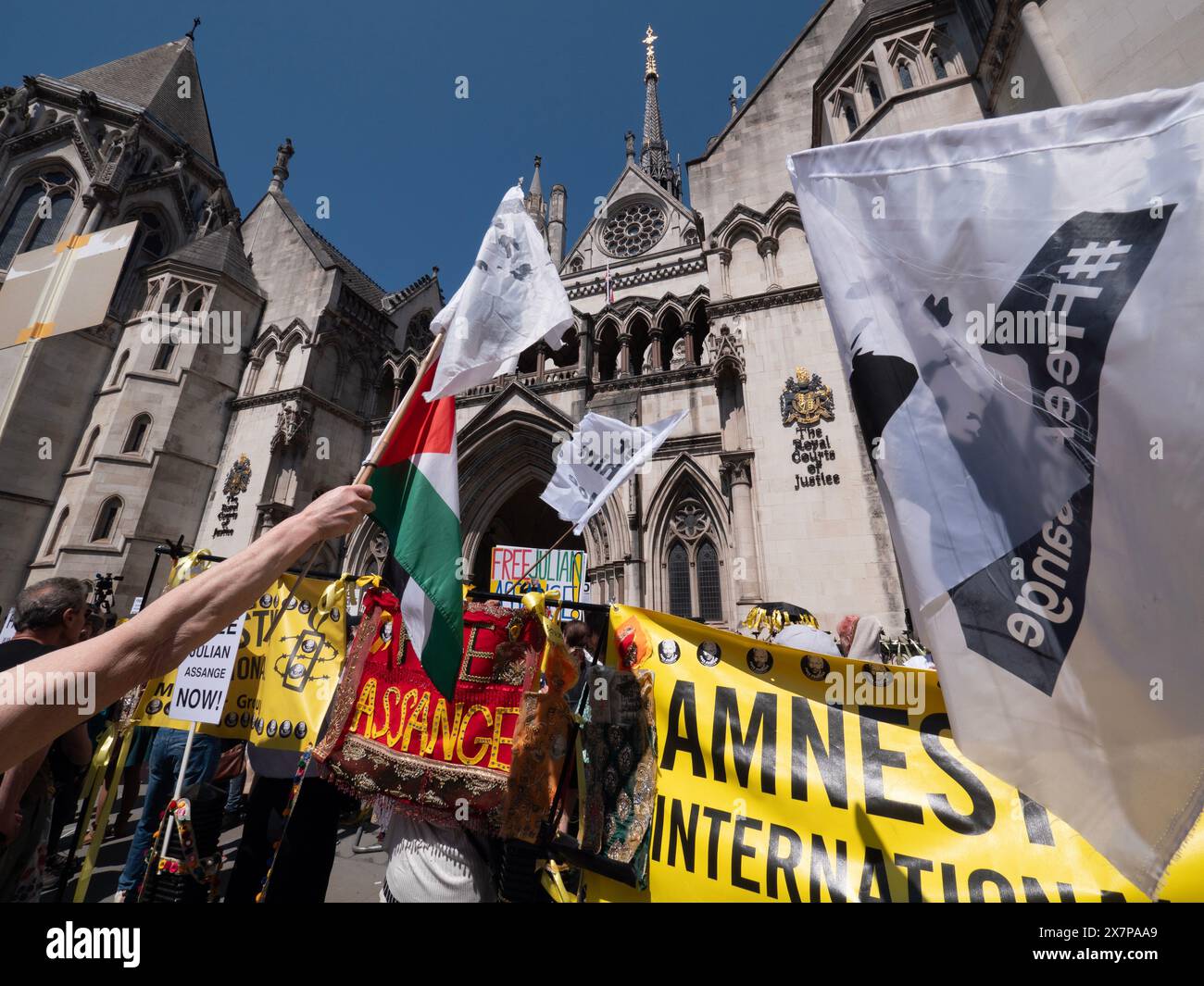 Supporters of WikiLeaks founder Julian Assange gather outside the Royal Courts of Justice (High Court) in London, UK, on 20 May 2024. They are awaiting a pivotal ruling on whether Assange can appeal his extradition to the United States on espionage charges. In a significant legal victory, two senior judges granted him the right to a full appeal, primarily on the grounds that his First Amendment rights might be limited due to his Australian nationality. This decision ultimately led to a plea deal and his release from Belmarsh Prison in June 2024 Stock Photo