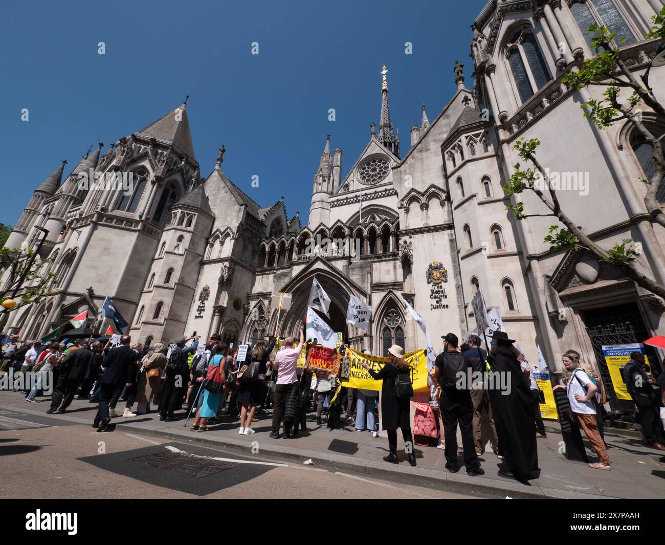 Supporters of WikiLeaks founder Julian Assange gather outside the Royal Courts of Justice (High Court) in London, UK, on 20 May 2024. They are awaiting a pivotal ruling on whether Assange can appeal his extradition to the United States on espionage charges. In a significant legal victory, two senior judges granted him the right to a full appeal, primarily on the grounds that his First Amendment rights might be limited due to his Australian nationality. This decision ultimately led to a plea deal and his release from Belmarsh Prison in June 2024 Stock Photo