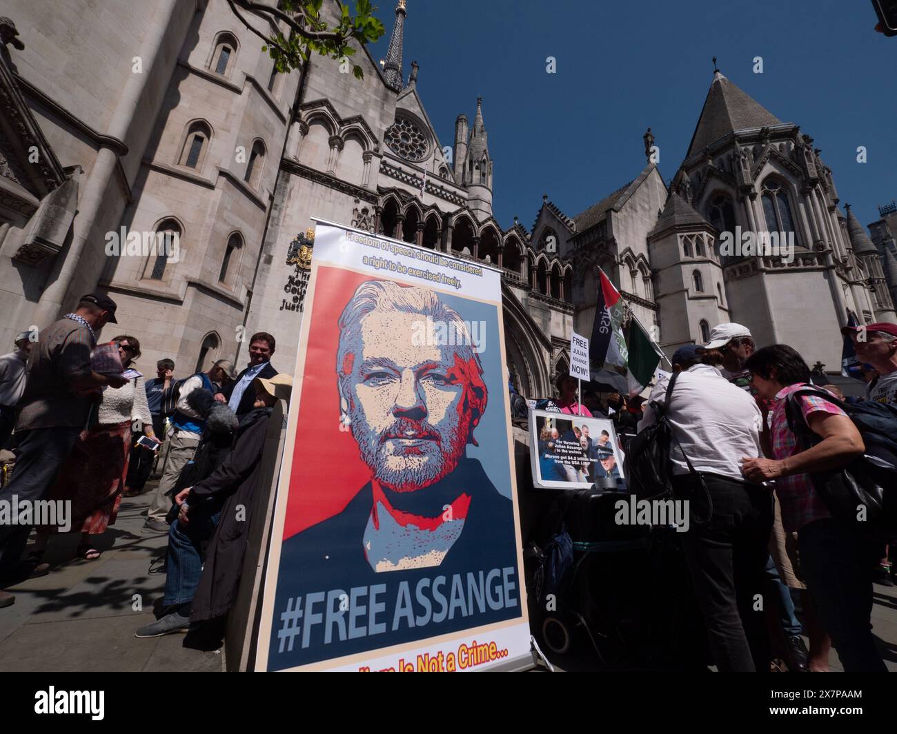 Supporters of WikiLeaks founder Julian Assange gather outside the Royal Courts of Justice (High Court) in London, UK, on 20 May 2024. They are awaiting a pivotal ruling on whether Assange can appeal his extradition to the United States on espionage charges. In a significant legal victory, two senior judges granted him the right to a full appeal, primarily on the grounds that his First Amendment rights might be limited due to his Australian nationality. This decision ultimately led to a plea deal and his release from Belmarsh Prison in June 2024 Stock Photo