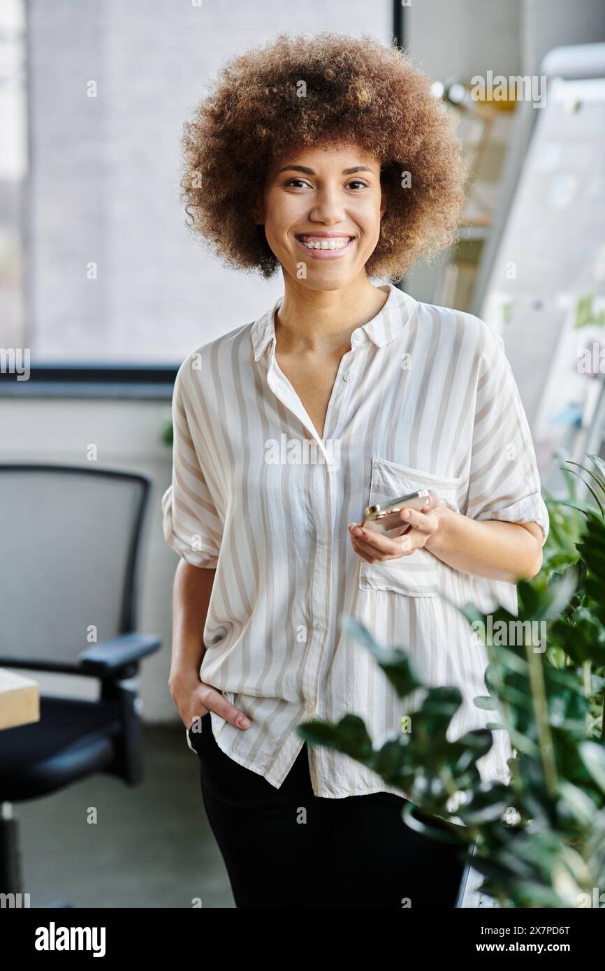 African american woman standing confidently in a modern office setting ...