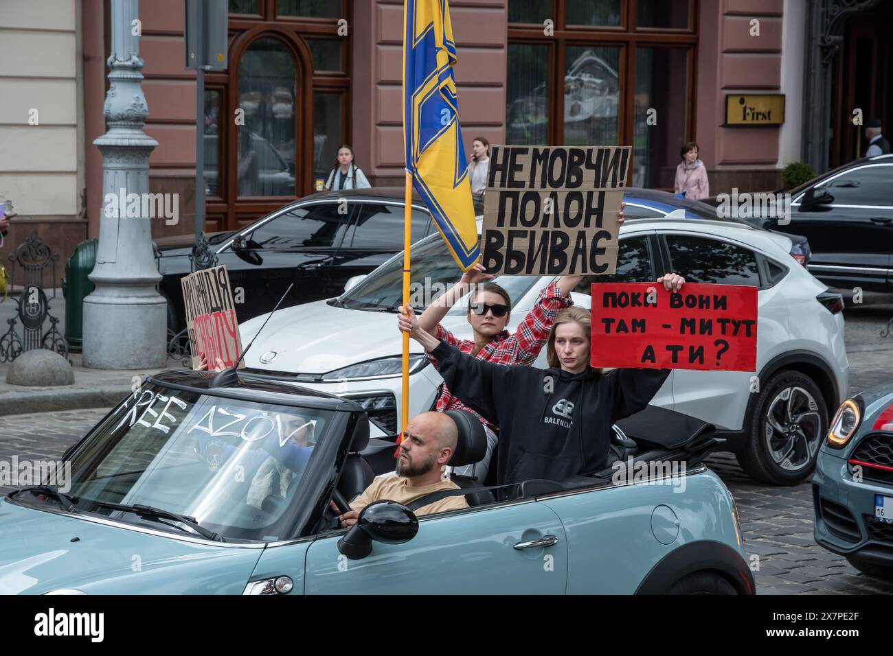 May 18, 2024, Lviv, Ukraine: People with banners drive in cars during the protest in the center of Lviv. Relatives and friends of captured defenders of Mariupol, holding banners and flags, participated in the ''Don't be silent. Capture kills. Two years of captivity'' protest in Lviv. The event, organized by the Association of Families of Defenders of Azovstal, commemorated the anniversary of the captivity of Ukrainian defenders from the Azovstal plant. On May 20, 2022, these defenders left the plant and were captured by the Russians. Over 2,000 Ukrainian soldiers remain in captivity under terr Stock Photo