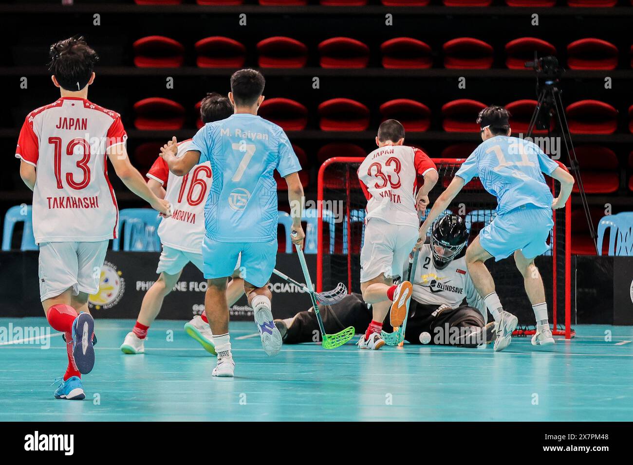 Pasig City, Philippines. 21st May, 2024. Damien Wan (2nd R) of Singapore saves the ball during the 2024 Men's World Floorball Championships qualifications between Singapore and Japan in Pasig, the Philippines, on May 21, 2024. Credit: Rouelle Umali/Xinhua/Alamy Live News Stock Photo