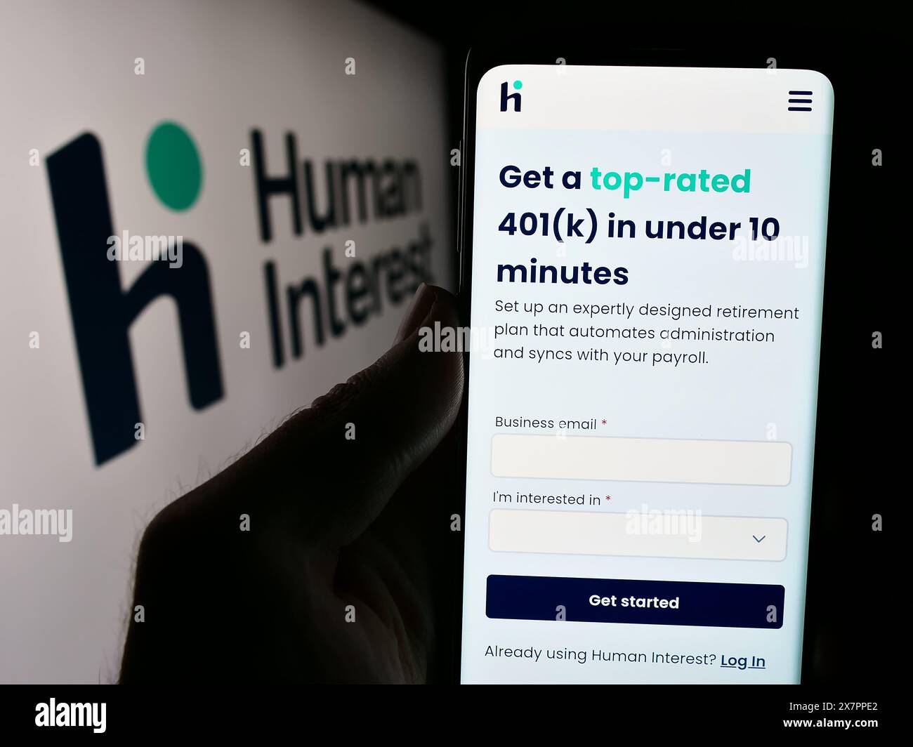 Person holding smartphone with webpage of US financial services company