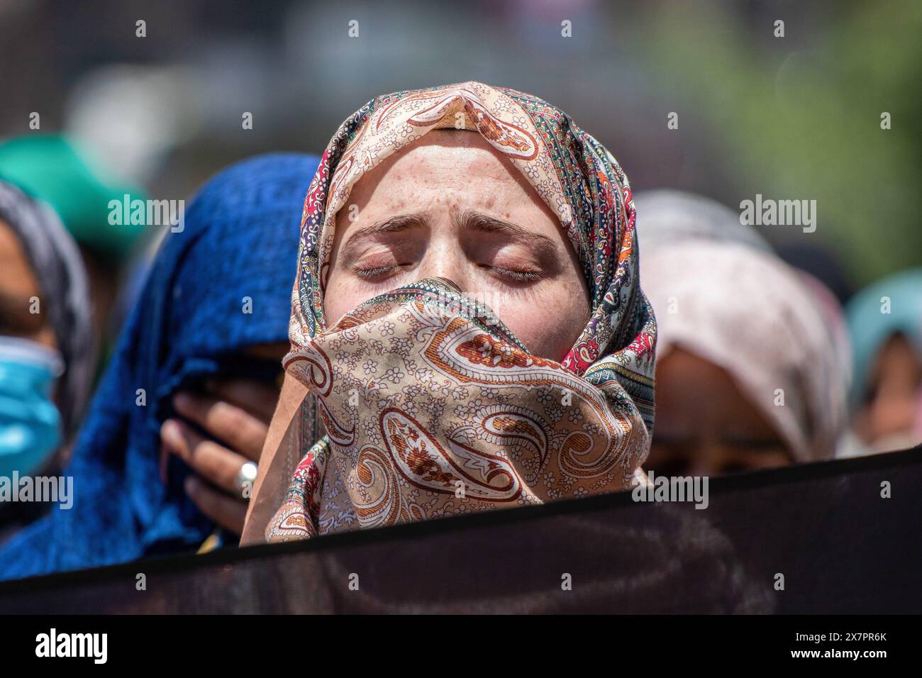 May 21, 2024, Srinagar, India: A Muslim woman mourns the death of Iranian President Ebrahim Raisi and other officials during a rally in Srinagar Hundreds of demonstrators gathered for the march to mourn the tragic death of Iran's President Ebrahim Raisi, along with the country's foreign minister Hossein Amirabdollahian and other officials. The officials were found dead on May 20 after rescue teams found their helicopter crashed in dense fog in a mountainous region of the country's northwest, officials and state media said. (Credit Image: © Faisal Bashir/SOPA Images via ZUMA Press Wire) EDITORI Stock Photo