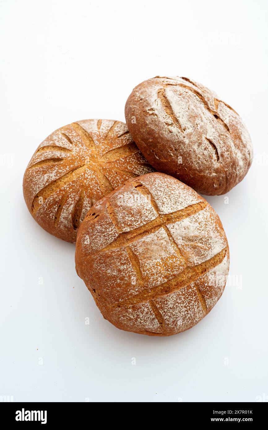 A duo of artisanal sourdough bread loaves with a dusting of flour ...