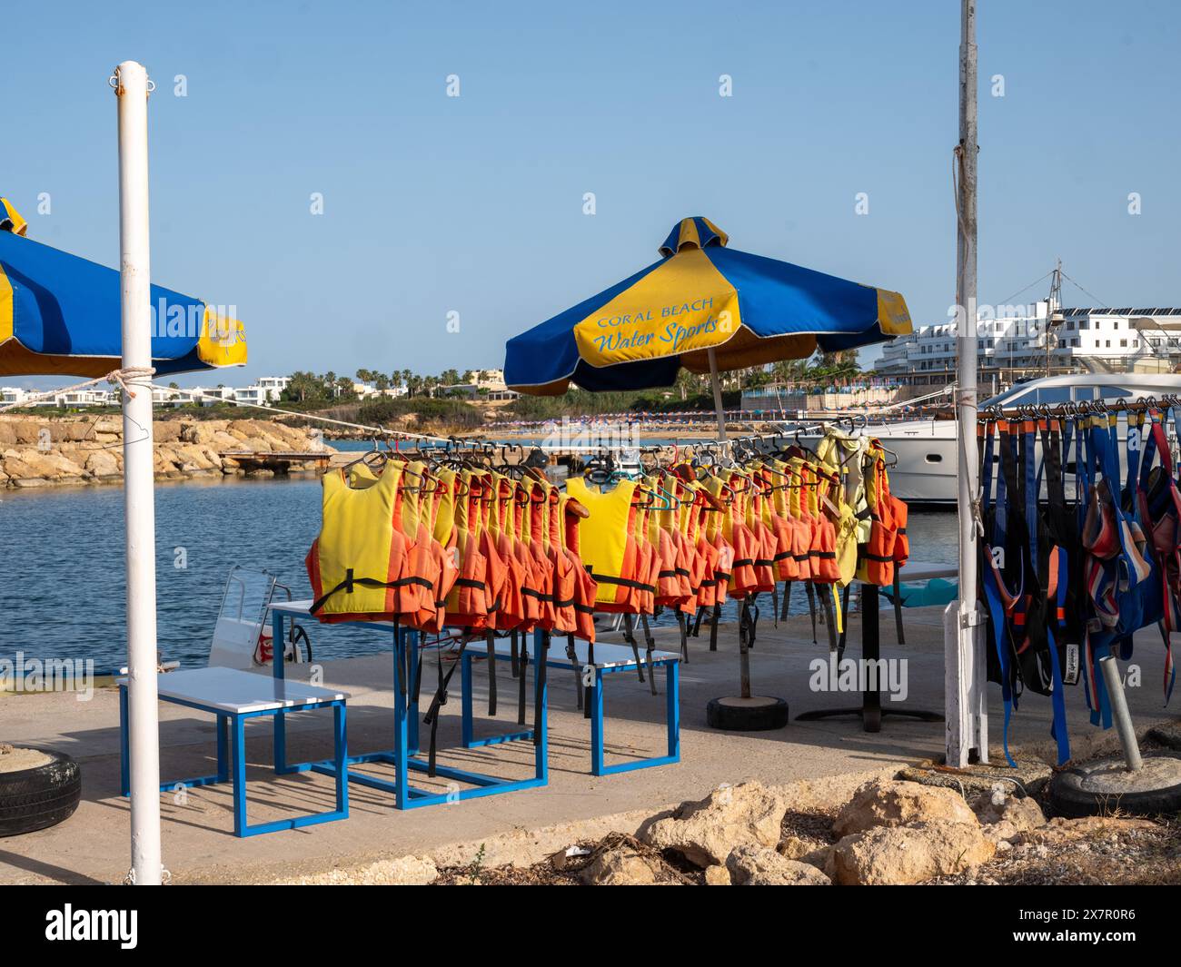 May 2024, Surf school hanging life jackets in the morning sun near Pafos, Cyprus. Stock Photo
