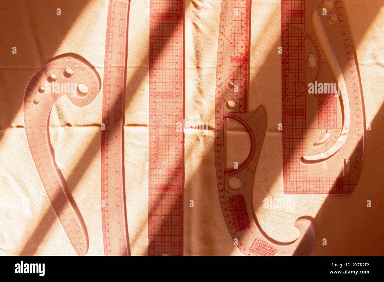 Shadows dance across beige fabric, highlighting the essential tools of ...
