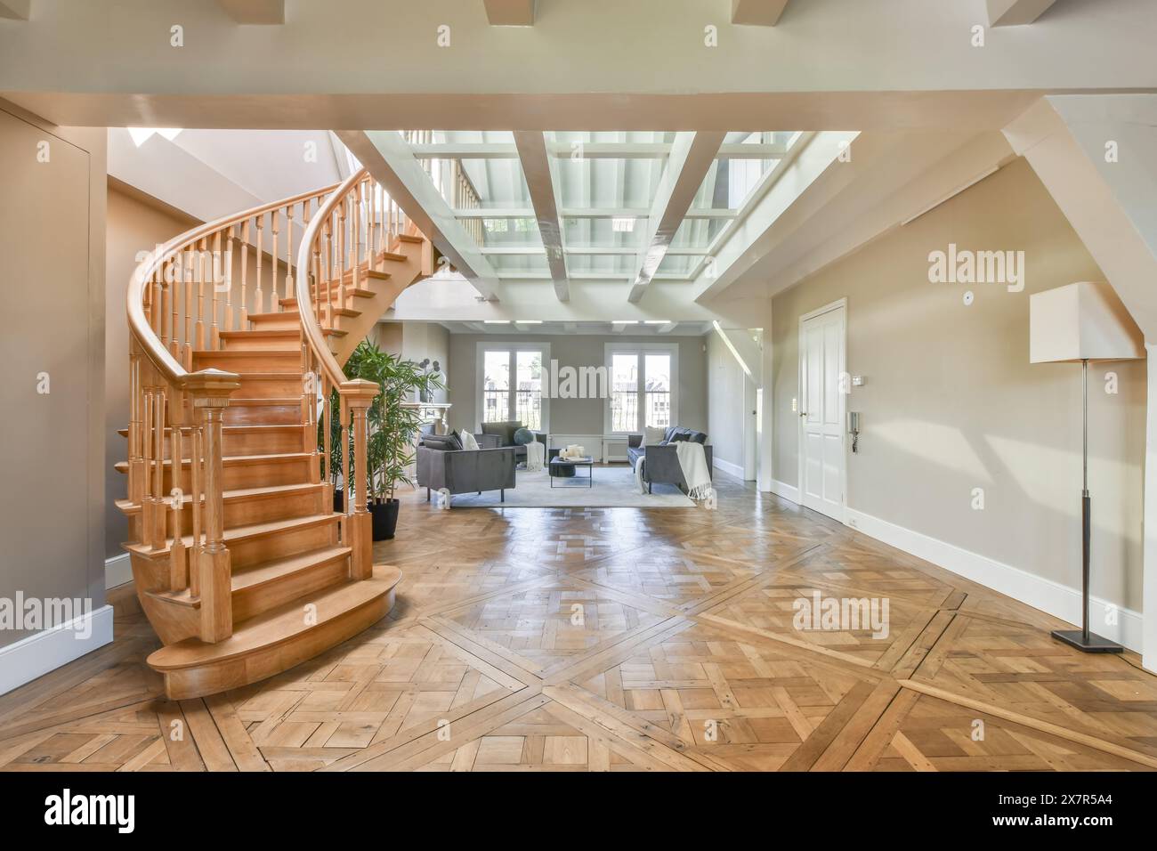 An expansive modern living room with a wooden spiral staircase and ...