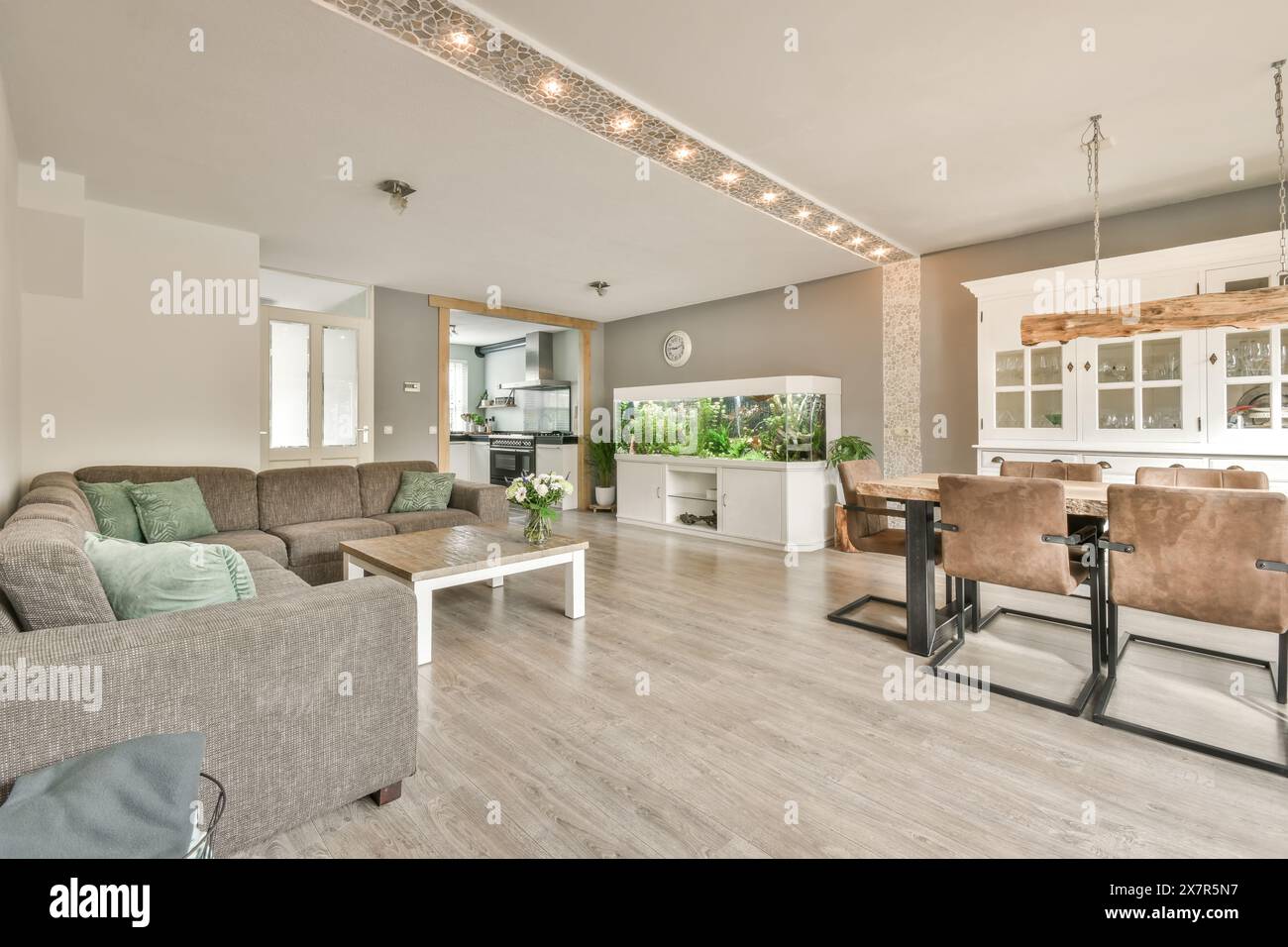 An open-plan living room seamlessly connects to a kitchen and dining ...