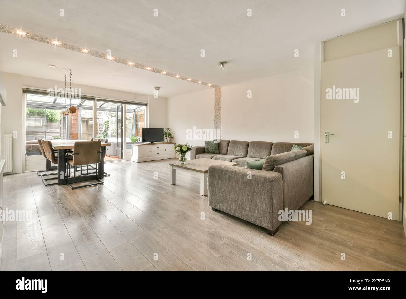 Bright and spacious living room with modern furniture and large windows ...