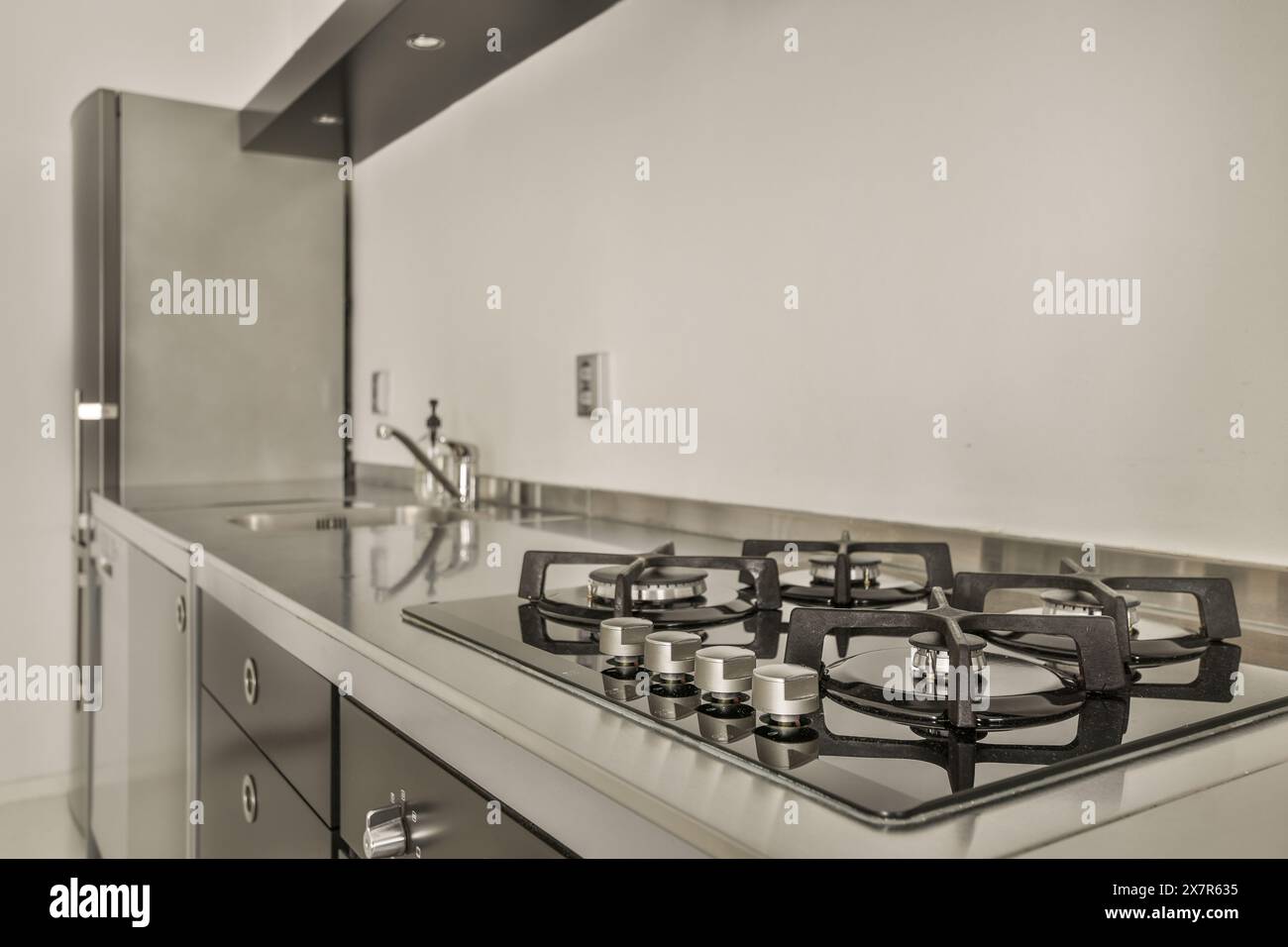 A contemporary kitchen featuring a clean, modern gas stove with
