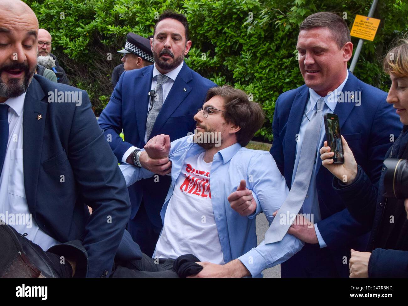 London, UK. 21st May 2024. Security carry protesters out of the venue. Climate activists staged a protest outside fossil fuel giant Shell's Annual General Meeting at the Intercontinental Hotel, The O2, in Greenwich. A group of activists also disrupted the event inside the venue before being thrown out by security.. Credit: Vuk Valcic/Alamy Live News Stock Photo