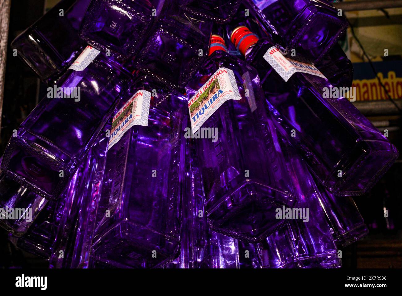 Several bottles of Tiquira, cassava spirit, tuber of the plant with scientific name: Manihot esculenta, for sale in the market in São Luis MA, Brazil Stock Photo