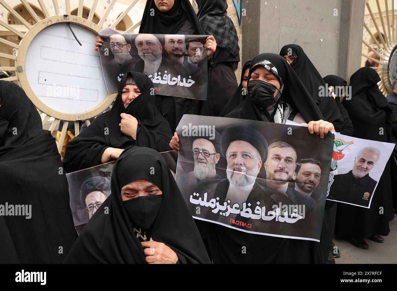 Tabriz, East Azerbaijan, Iran. 21st May, 2024. Iranian veiled women holding a portrait of late president Ebrahim Raisi during a funeral procession in Tabriz, the capital of Iran's East Azerbaijan province, on May 21, 2024, for late president Ebrahim Raisi and seven others killed with him in a helicopter crash two days ago. Tens of thousands of Iranians gathered in Tabriz on May 21 to mourn Raisi and seven members of his entourage who were killed in the crash on a fog-shrouded mountainside in northwestern Iran. Credit: ZUMA Press, Inc./Alamy Live News Stock Photo