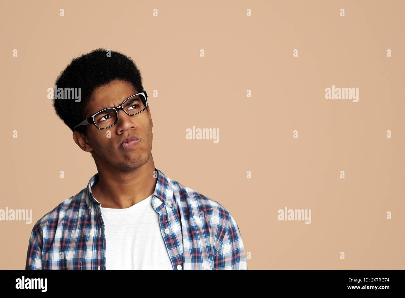 Thoughtful Afro Guy Thinking and Looking Aside Stock Photo