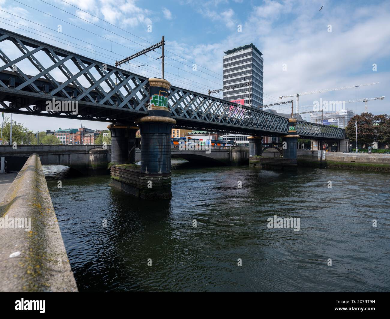 A railbridge crossing the River Liffey in Dublin city centre, Ireland. Stock Photo