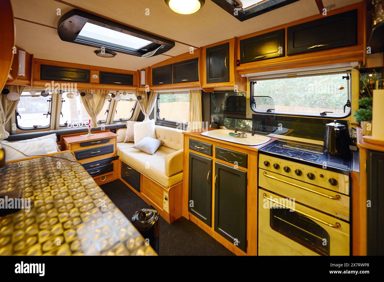 cozy kitchen and living area in recreational vehicle for a romantic getaway. Stock Photo