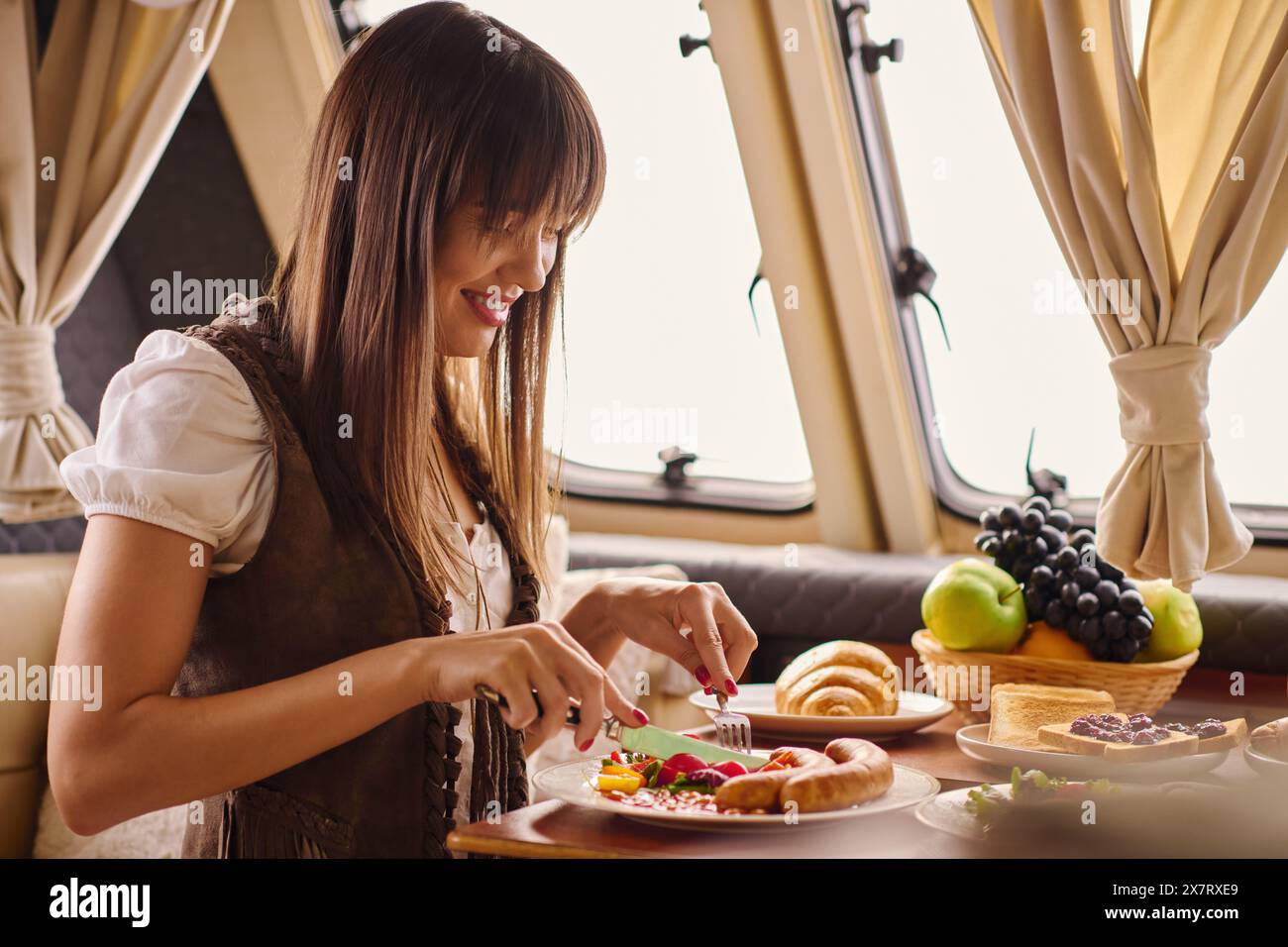 happy woman indulging in a delicious meal at a table in a cozy setting, savoring each bite of lunch. Stock Photo