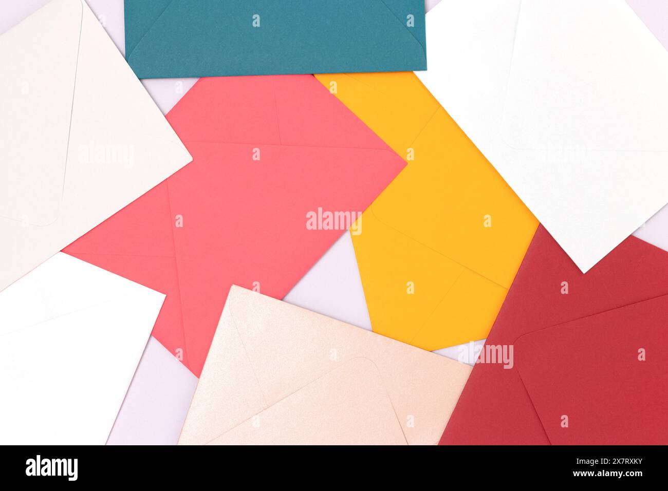 Multicolored envelopes scattered on a blue background. Creative background. Stock Photo